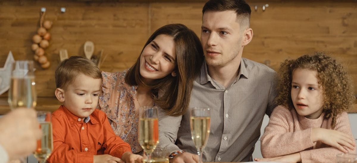 A joyful family gathers for a festive dinner, exchanging warmth and togetherness.
